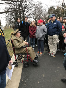John A. Pildner, Sr. addresses a group of visitors at the memorial marker for the Veterans of the Battle of the Bulge. 